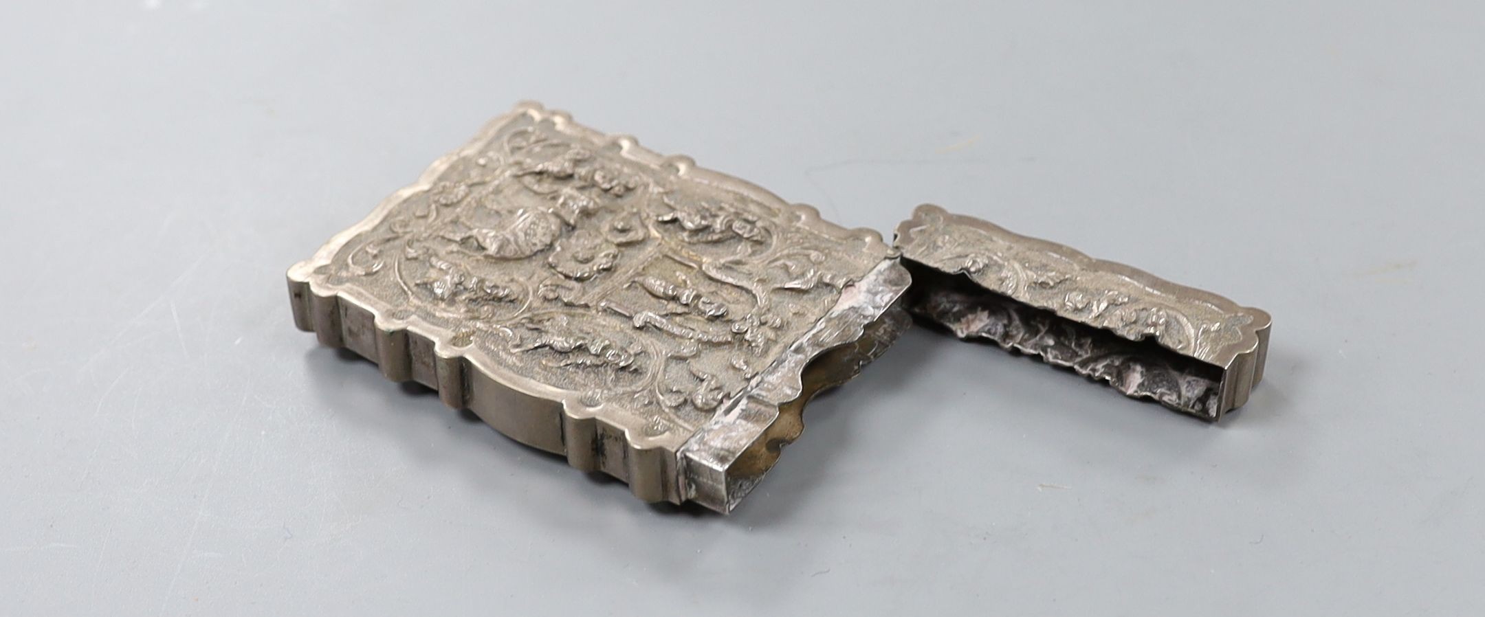 An Indian embossed white metal card case, decorated with figures and elephants, 97mm